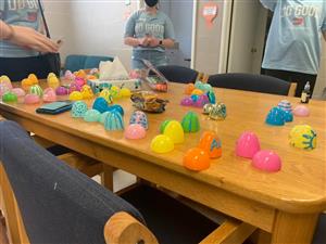plastic easter eggs painted with puff paint on a table. 